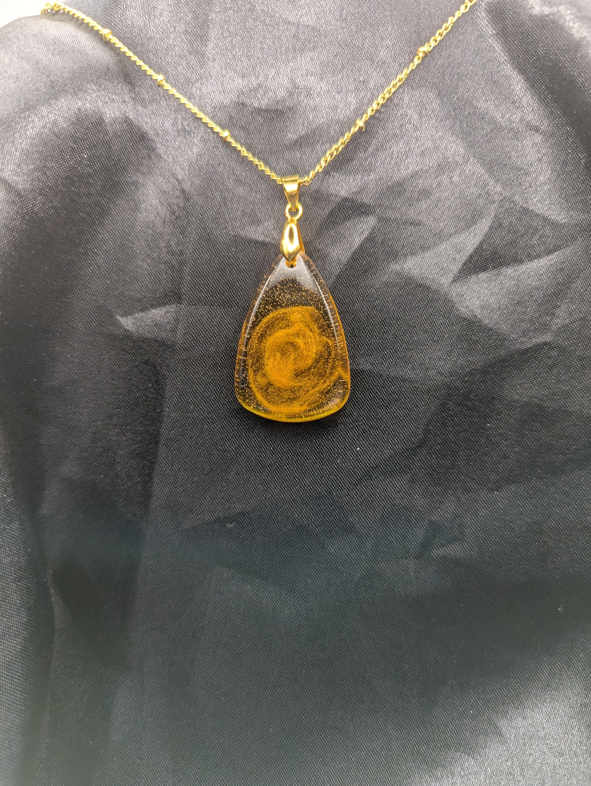 Yellow & Orange Swirl Rounded Triangle Resin Pendant Necklace on a gold pinch bail and a gold plated metal chain.