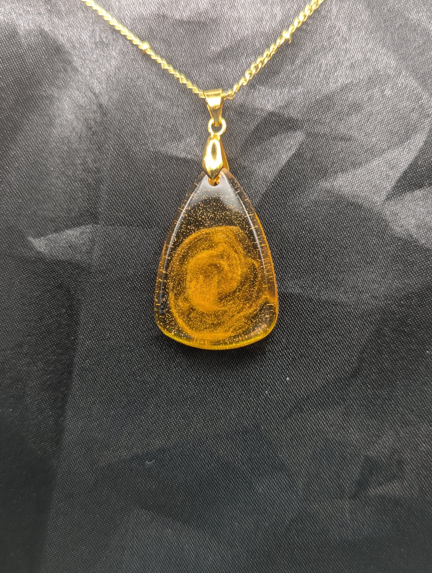 Yellow & Orange Swirl Rounded Triangle Resin Pendant Necklace on a gold pinch bail and a gold plated metal chain.