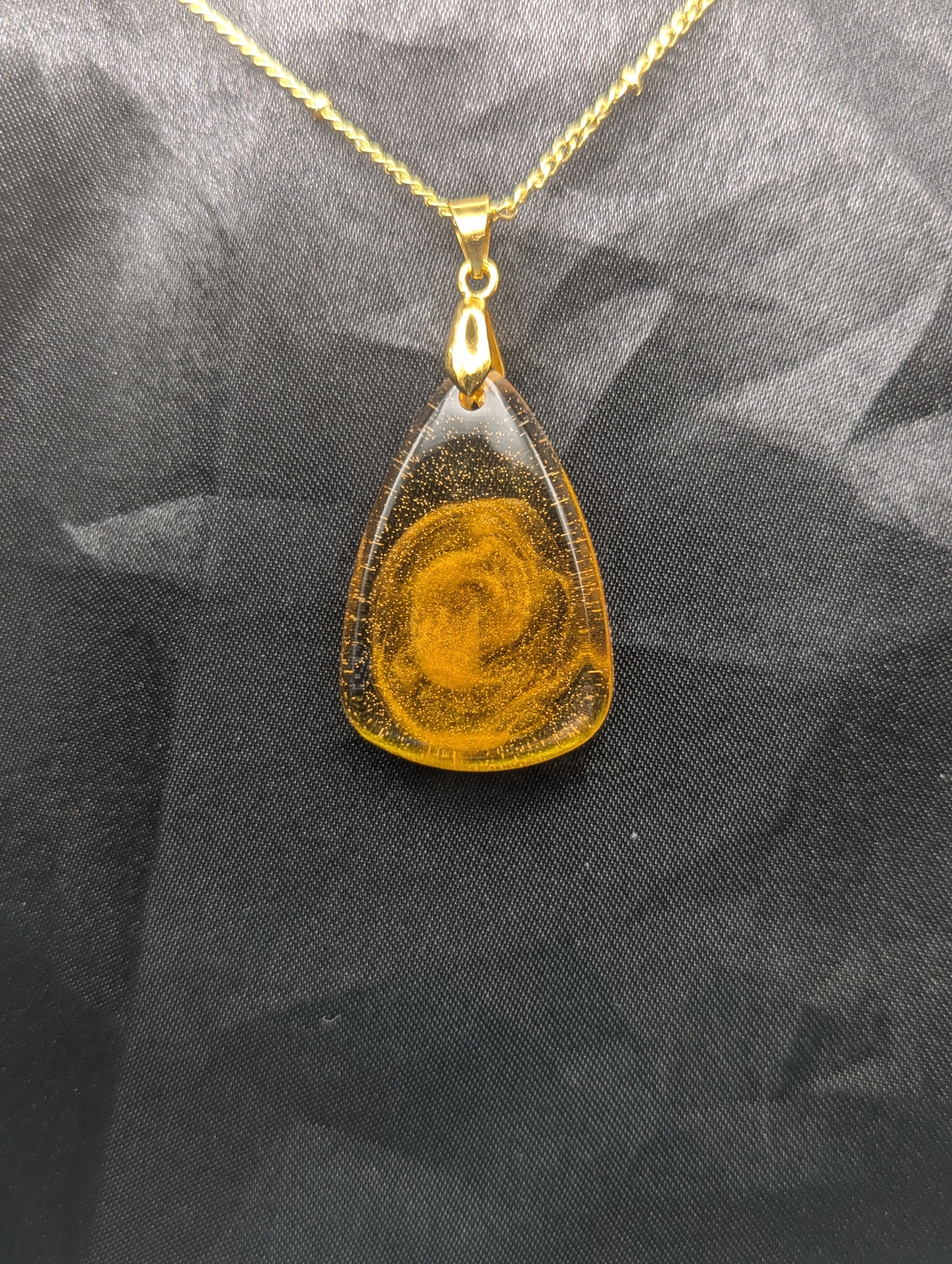 Yellow & Orange Swirl Rounded Triangle Resin Pendant Necklace on a gold pinch bail and a gold plated metal chain.