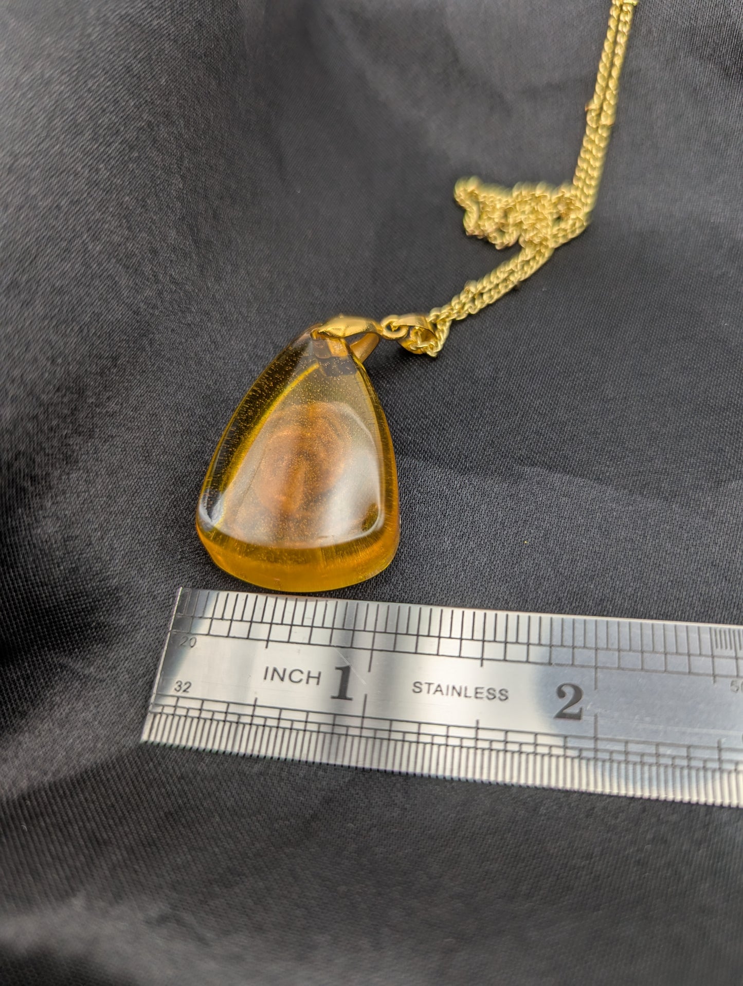 Size example pic of pendant size in inches, showing pendant is about 1 inch wide at the base