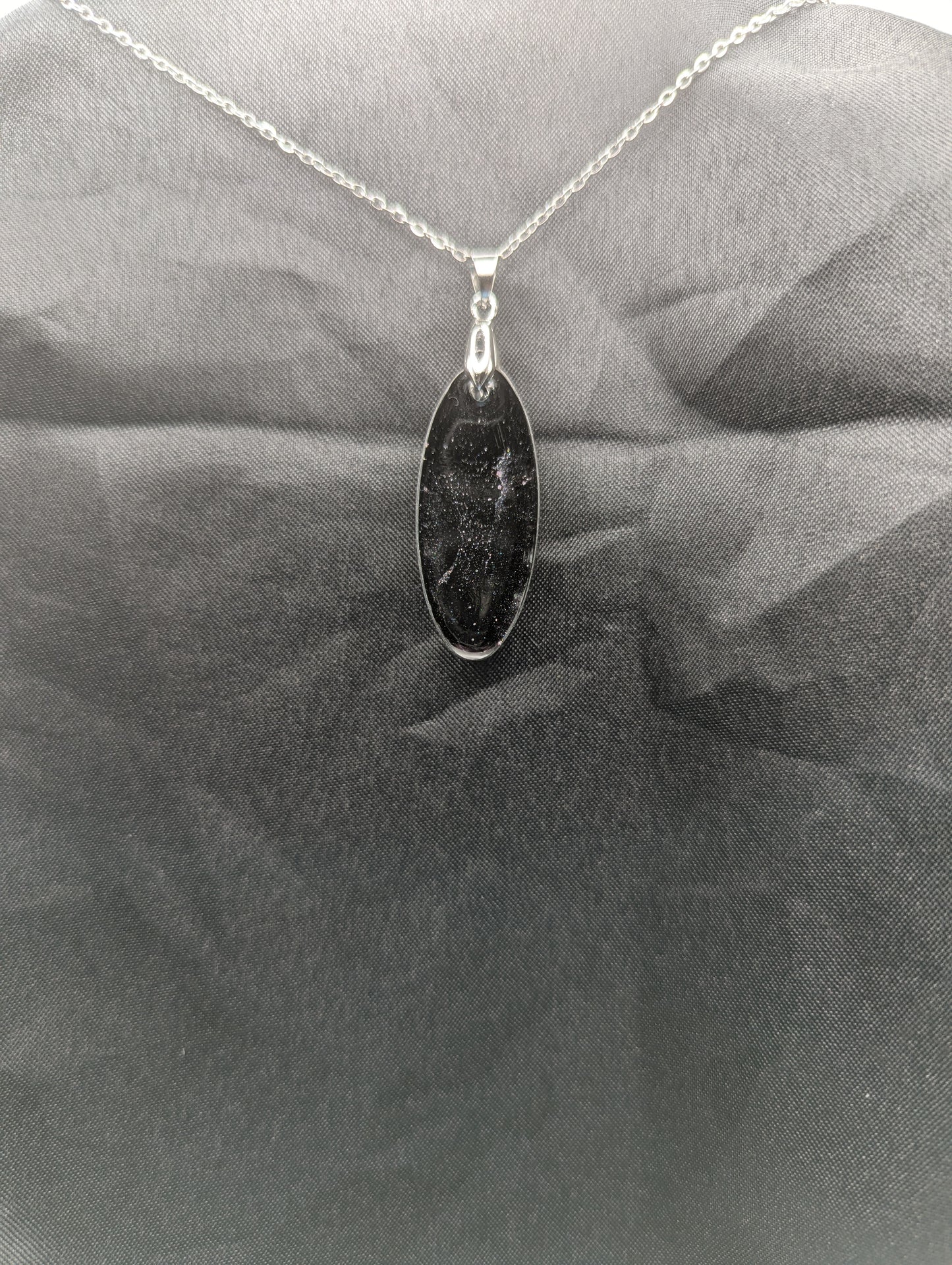 Back view of Black & Purple Swirl Ellipse Pendant on a silver pinch bail & stainless steel chain.