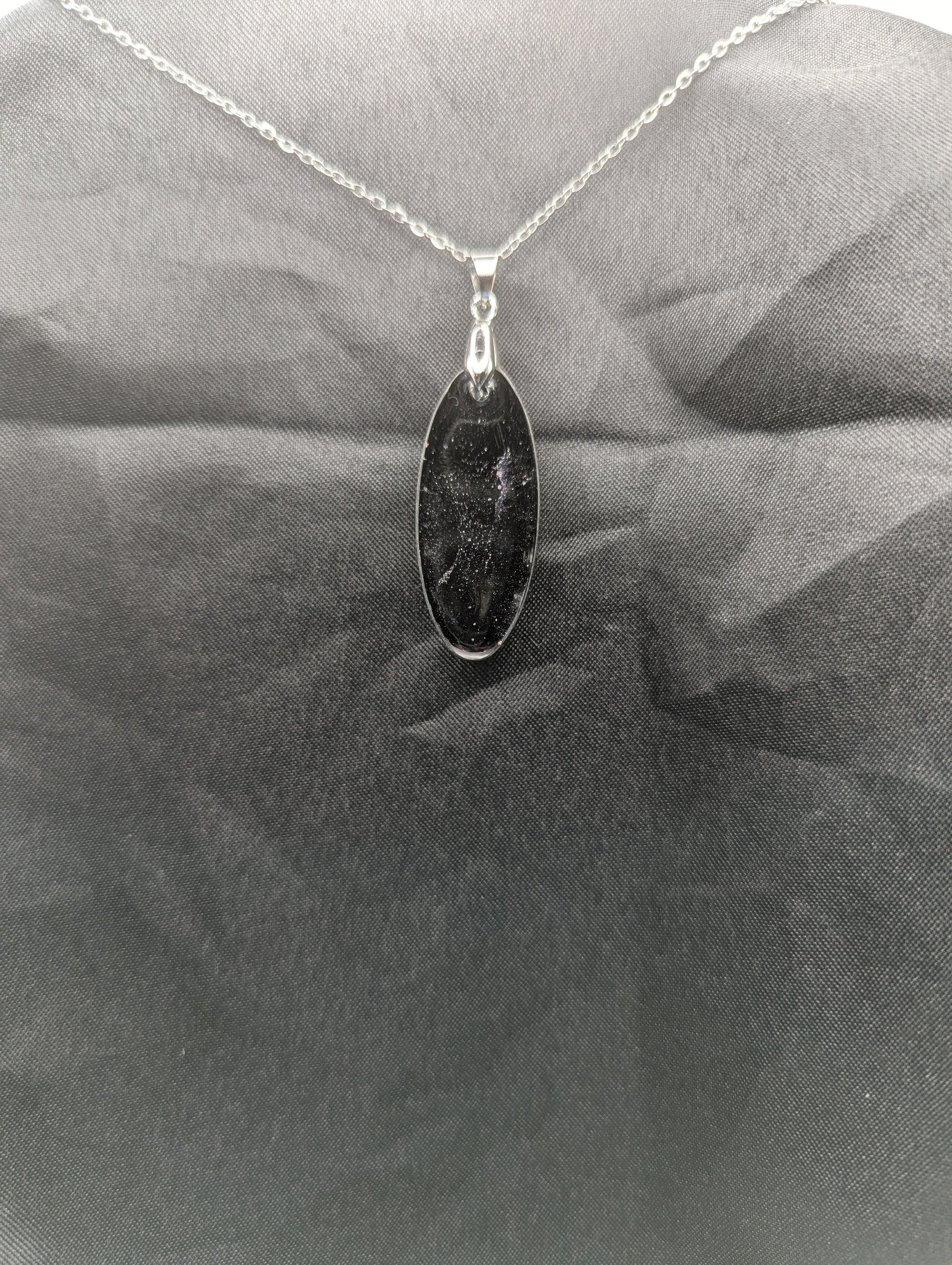 Back view of Black & Purple Swirl Ellipse Pendant on a silver pinch bail & stainless steel chain.