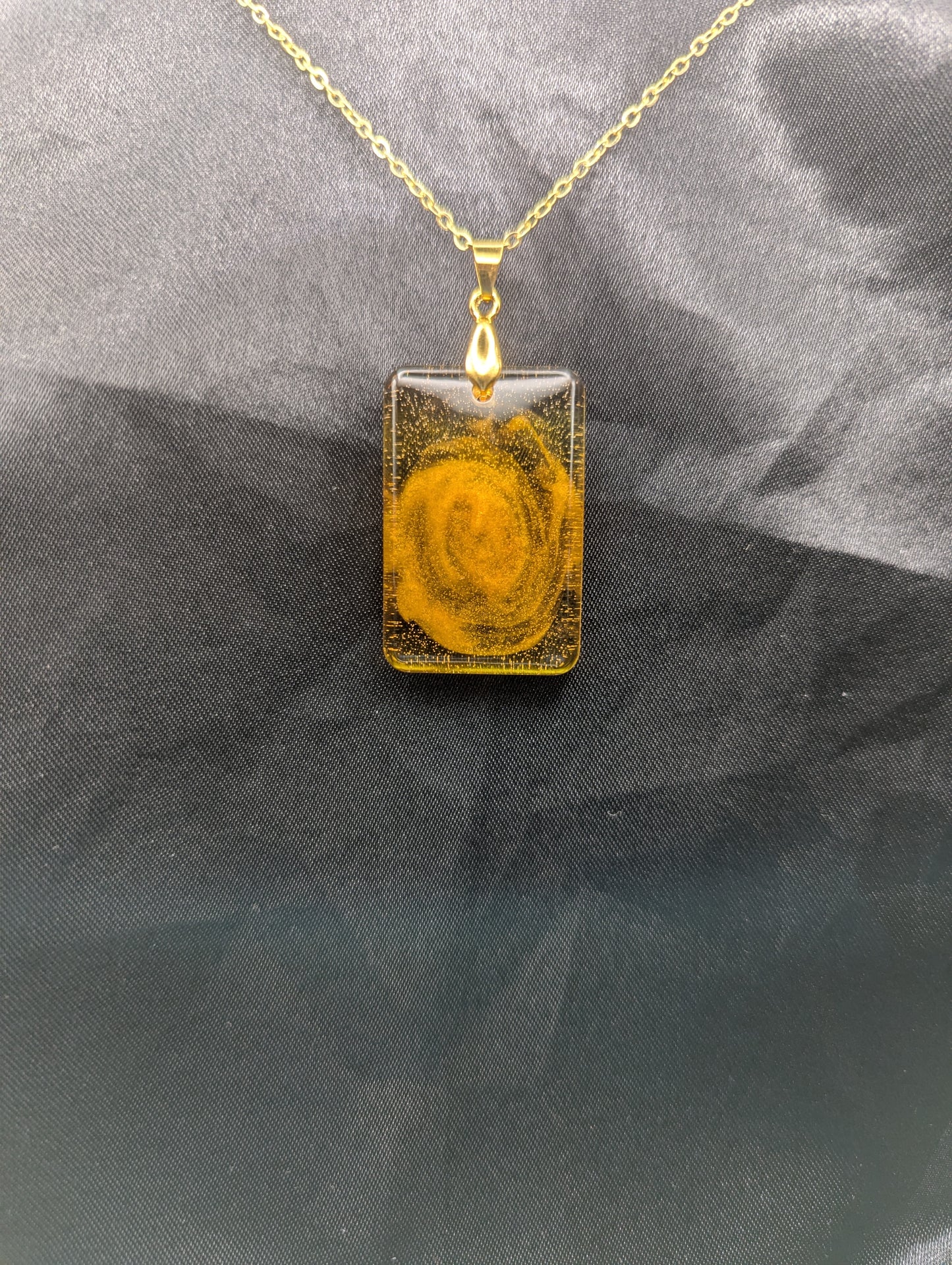 Yellow & Orange Swirl Rectangle Resin Pendant on a gold pinch bail & gold plated metal chain.