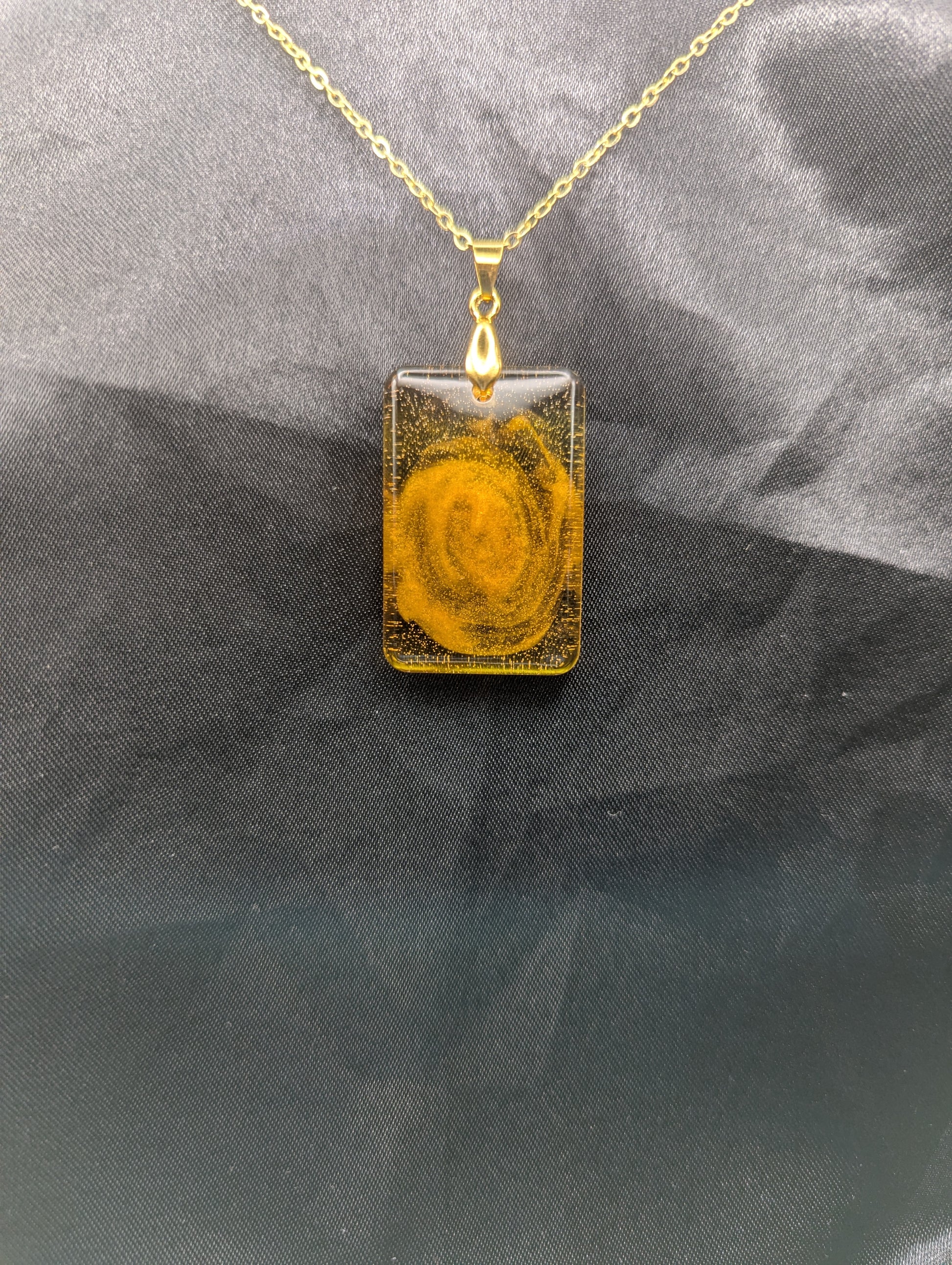 Yellow & Orange Swirl Rectangle Resin Pendant on a gold pinch bail & gold plated metal chain.