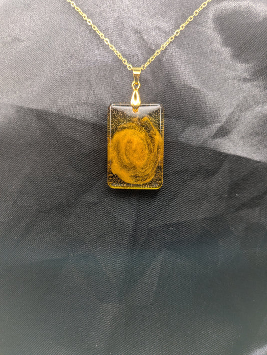 Yellow & Orange Swirl Rectangle Resin Pendant on a gold pinch bail & gold plated metal chain.