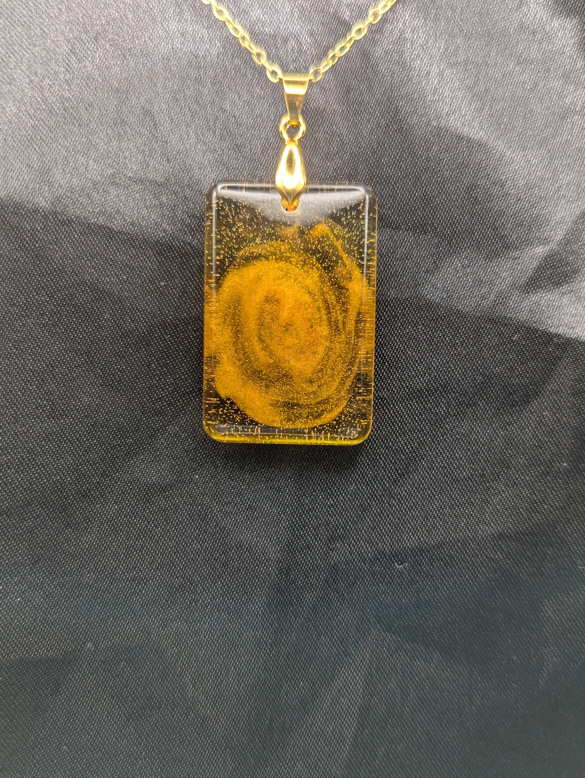Yellow & Orange Swirl Rectangle Resin Pendant on a gold pinch bail & gold plated metal chain.