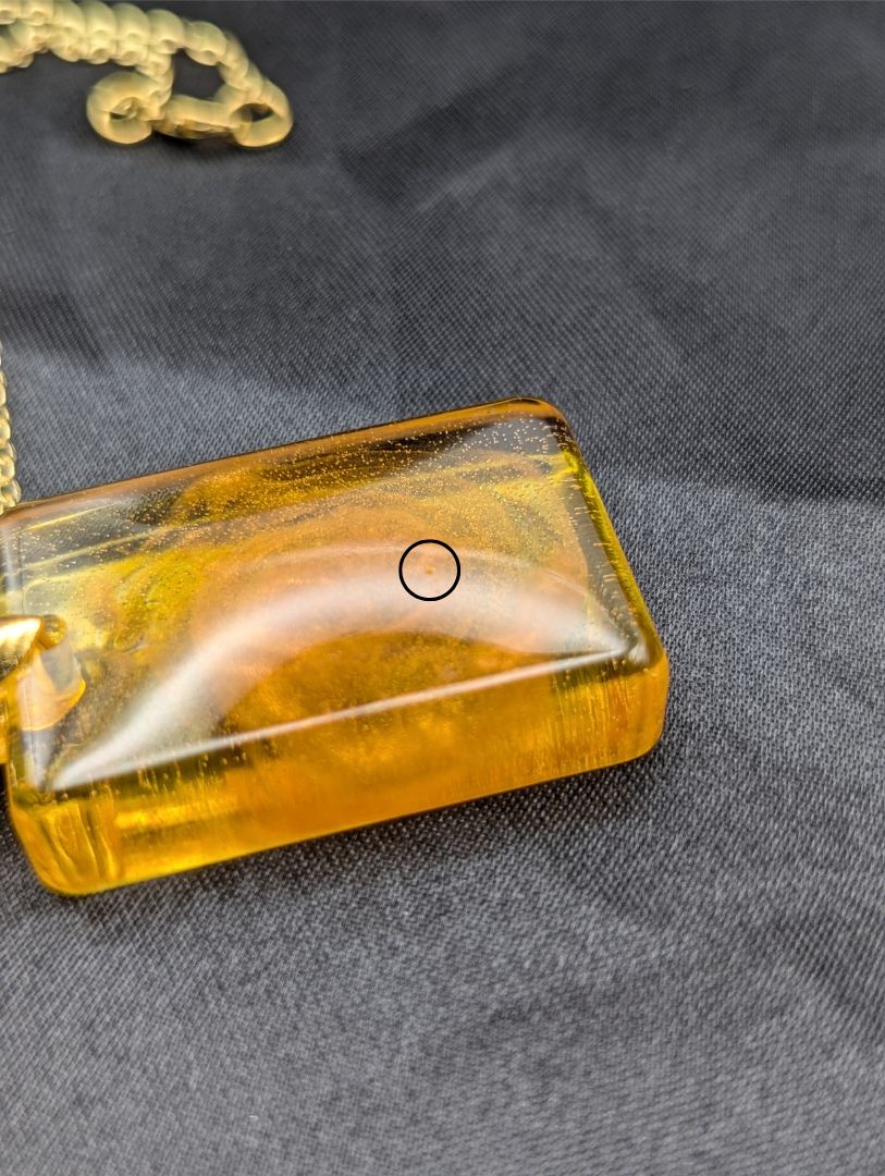 Yellow & Orange Swirl Rectangle Resin Pendant on a gold pinch bail & gold plated metal chain.