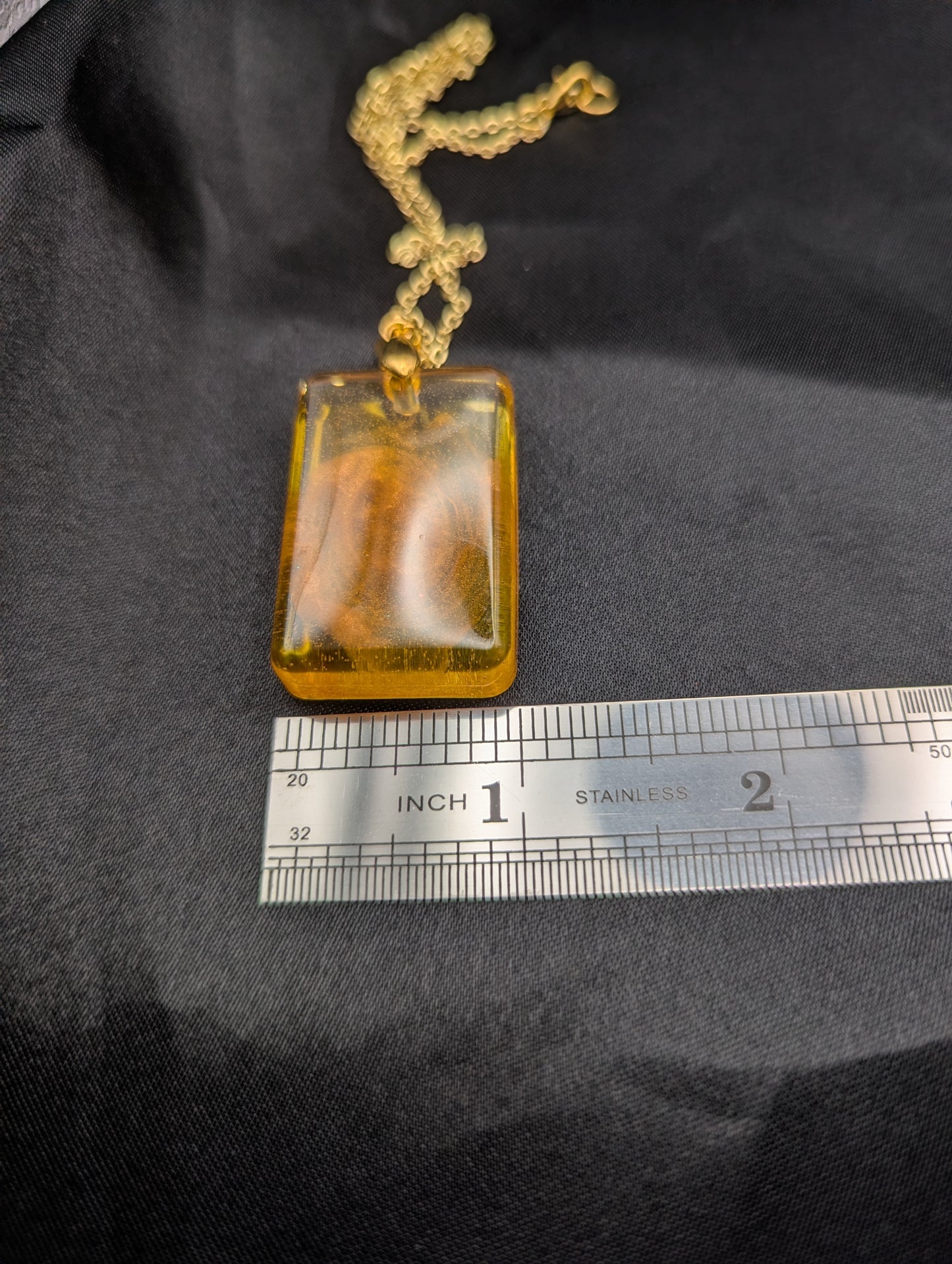 Size example pic of pendant size in inches, showing pendant is about 1 inch wide