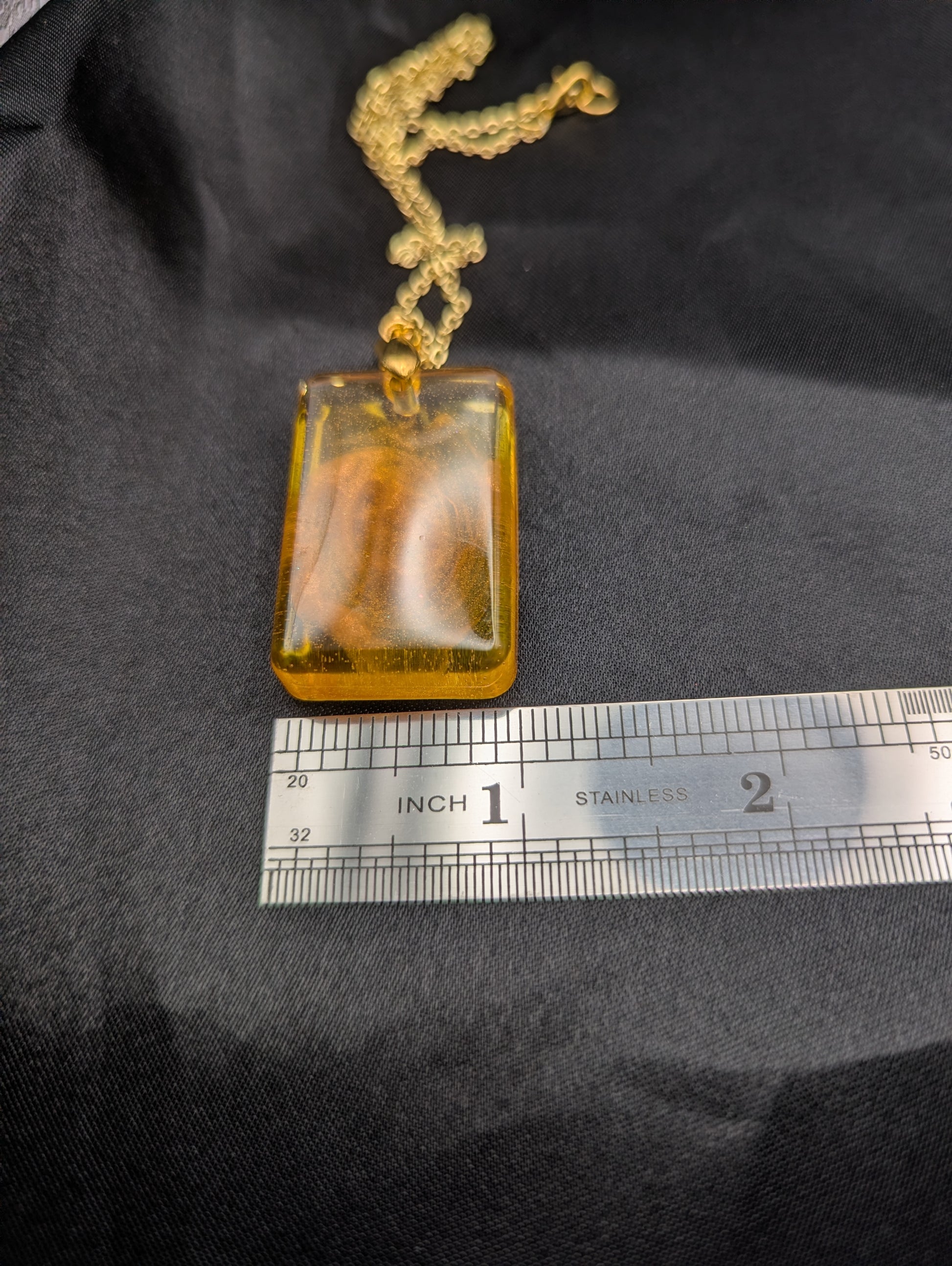 Size example pic of pendant size in inches, showing pendant is about 1 inch wide