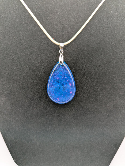 Teardrop Resin Pendant Necklace - Blue & sparkly in color with pops of bright purple. Resin necklace on a waxed cotton cord.
