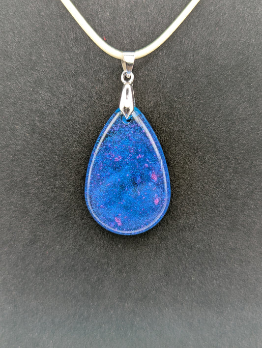Teardrop Resin Pendant Necklace - Blue & sparkly in color with pops of bright purple. Resin necklace on a waxed cotton cord.