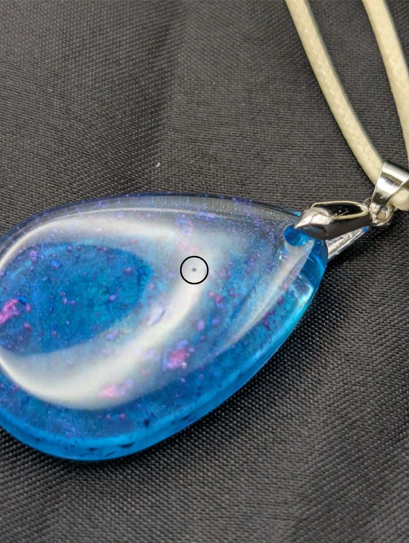 Teardrop Resin Pendant Necklace - Blue & sparkly in color with pops of bright purple. Resin necklace on a waxed cotton cord.