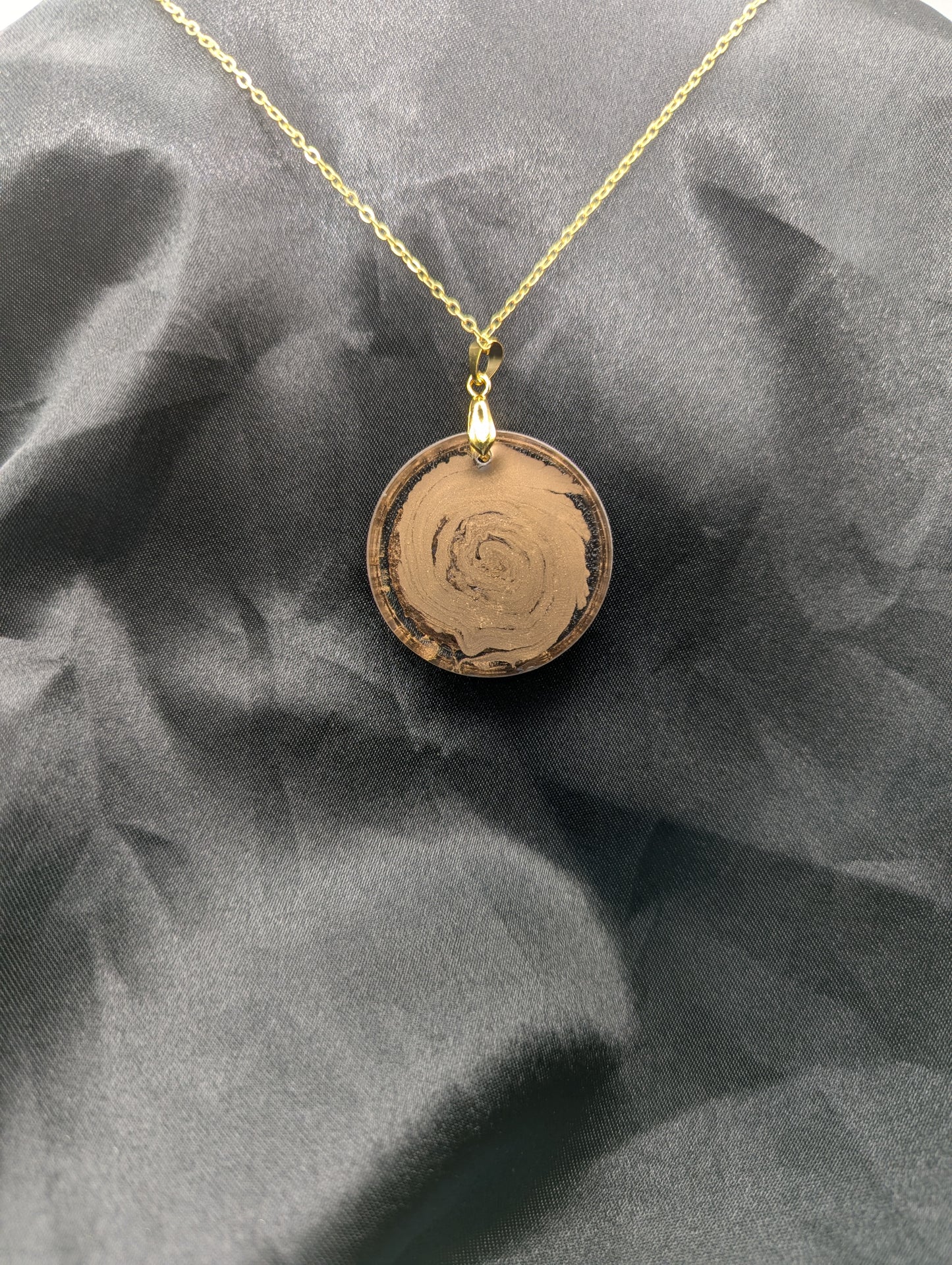 Back view of Rich Gold Swirl Resin Circle Pendant on a gold pinch bail and gold plated metal chain.