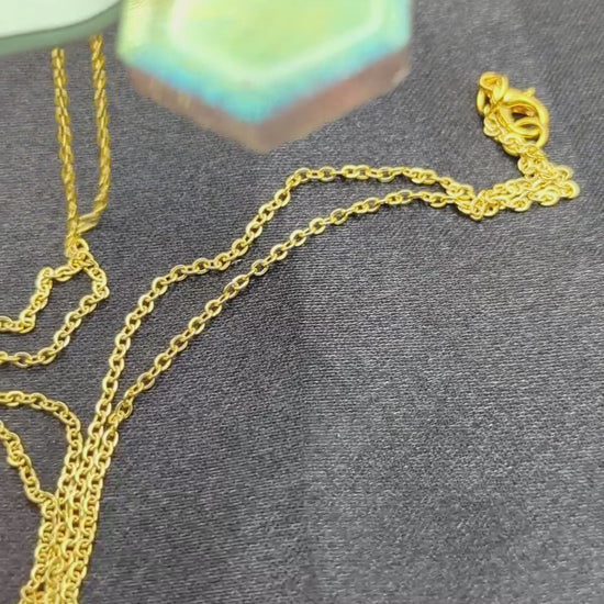 Hexagon shaped resin pendant necklace with color shift pigment on a gold plated metal chain