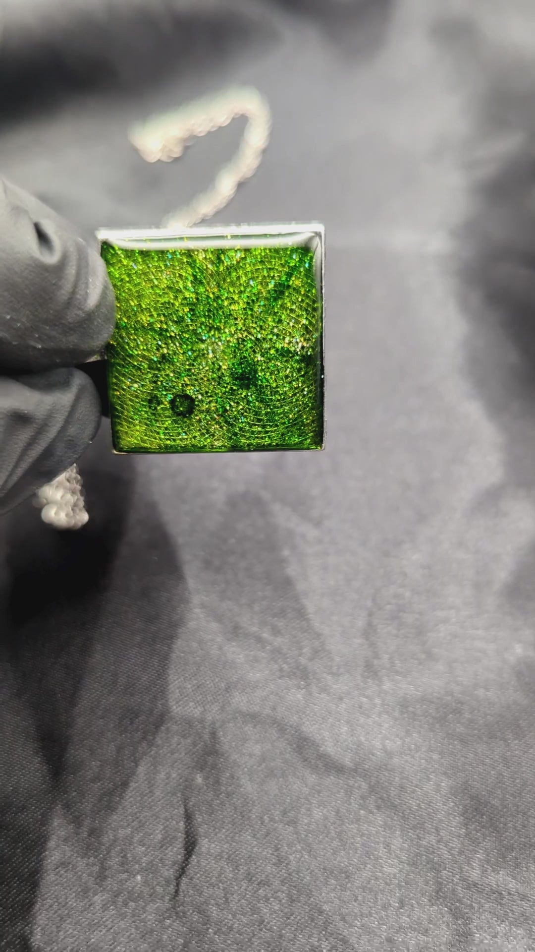Sparkly green resin pendant necklace in a square bezel on a stainless steel chain